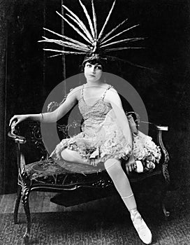 Portrait of female dancer with feather headdress photo