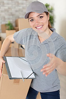 portrait female delivery driver with clipboard