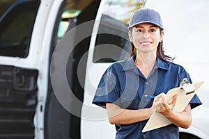 Portrait Of Female Delivery Driver With Clipboard