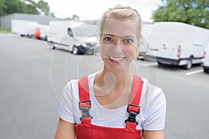 portrait female delivery driver wearing red dungarees