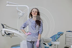 Portrait of female dentist .She standing in her dentist office.