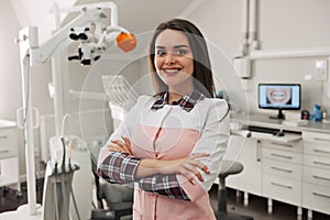 Portrait of female dentist .She standing in her dentist office