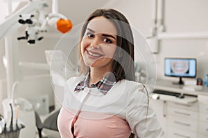 Portrait of female dentist .She standing in her dentist office
