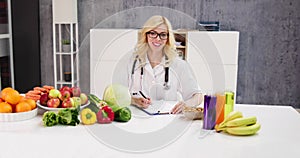 Portrait Of Female Dietician With Vegetables