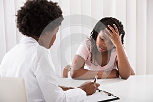 Female Doctor Comforting Depressed Patient photo