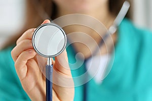 Portrait of female doctor holding stethoscope head