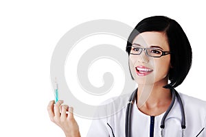 Portrait of female doctor holding syringe