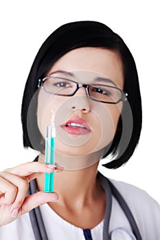 Portrait of female doctor holding syringe