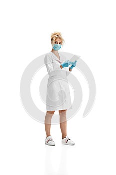 Portrait of female doctor, nurse or cosmetologist in white uniform and blue gloves over white background