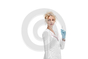 Portrait of female doctor, nurse or cosmetologist in white uniform and blue gloves over white background