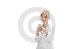 Portrait of female doctor, nurse or cosmetologist in white uniform and blue gloves over white background