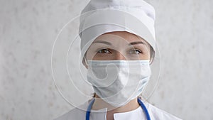Portrait of female doctor or nurse in uniform and mask looking straight at camera. Hard work, medical, epidemic concept