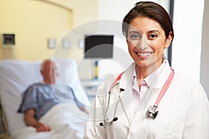 Portrait Of Female Doctor With Patient In Background