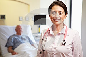 Portrait Of Female Doctor With Patient In Background