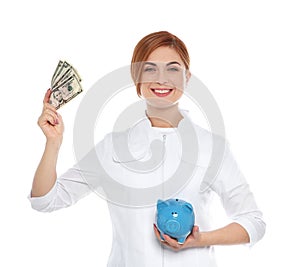 Portrait of female doctor with piggy bank and money