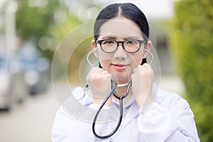 Portrait Of Female Doctor Standing Outside Hospital