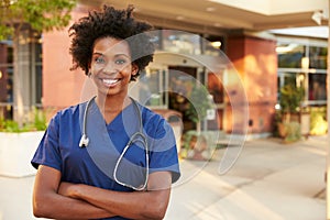 Portrait Of Female Doctor Standing Outside Hospital