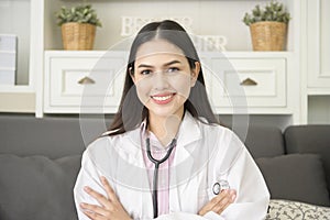 Portrait of Female doctor with stethoscope at office and smiling at camera