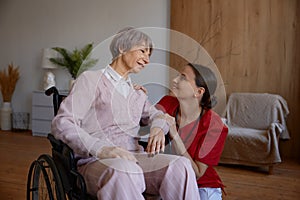 Portrait of female doctor talking to her patient during home visit