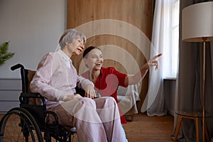 Portrait of female doctor talking to her patient during home visit