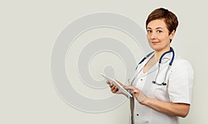 Portrait of a female doctor using her digital tablet. Female doctor using tablet and checking with analysis