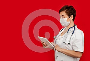 Portrait of a female doctor using her digital tablet. Female doctor using tablet and checking with analysis