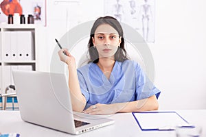 Portrait of a female doctor using her laptop computer at clinic