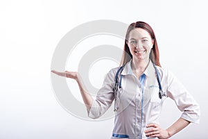 Portrait of a female doctor in a white uniform that shows a palm with copyspace in the studio on a white background.