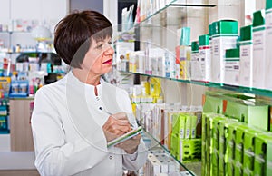 Portrait of female druggist working in pharmacy