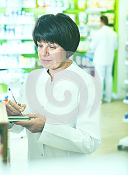 Portrait of female druggist working in pharmacy