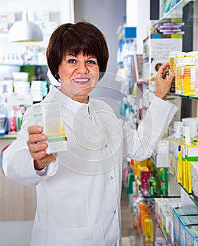 Portrait of  female druggist working in pharmacy photo