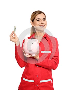 Portrait of female emergency doctor with piggy bank and money