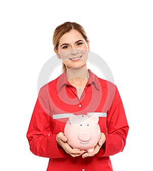 Portrait of female emergency doctor with piggy bank