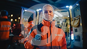 Portrait of a Female EMS Paramedic Proudly Standing in Front of Camera in High Visibility Medical