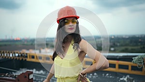 Portrait of a female engineer or architect. Portrait of female boss in dress with helmet looking at camera. slow-motion