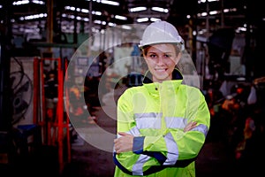 Portrait of female Engineer standing with confident against machine environment in factory, Engineers operating a machine in