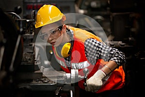 Portrait of female Engineer standing with confident against machine environment in factory, Engineers operating a machine in