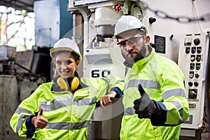 Portrait of female Engineer standing with confident against machine environment in factory, Engineers operating a machine in