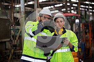 Portrait of female Engineer standing with confident against machine environment in factory, Engineers operating a machine in