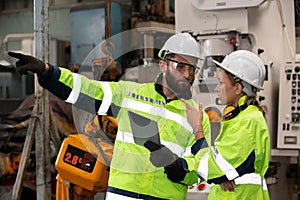 Portrait of female Engineer standing with confident against machine environment in factory, Engineers operating a machine in