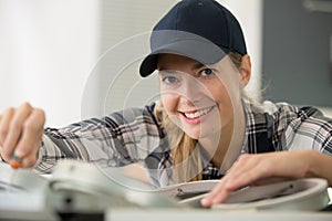 portrait female engineer using screwdriver