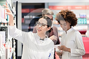 Portrait of a female experienced pharmacist reading indications photo