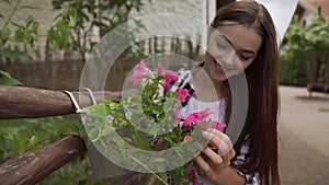 Portrait of female florist cutting dry leaves from flowers