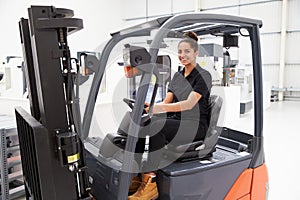 Portrait Of Female Fork Lift Truck Driver In Factory