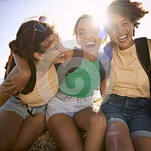 Portrait Of Female Friends With Backpacks On Vacation Taking A Break On Hike Through Countryside