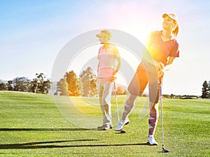 Portrait of female golfers checking ball on the golf course