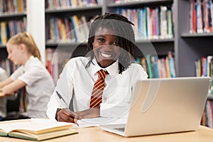 Portrait Of Female High School Student Wearing Uniform Working A photo