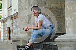 Portrait of female hipster with natural makeup and short haircut enjoying leisure time outdoors