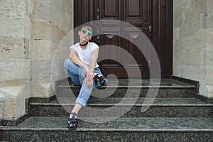 Portrait of female hipster with natural makeup and short haircut enjoying leisure time outdoors