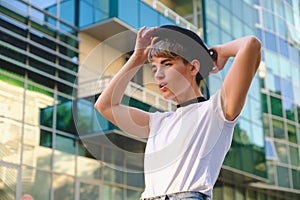 Portrait of female hipster with natural makeup and short haircut enjoying leisure time outdoors